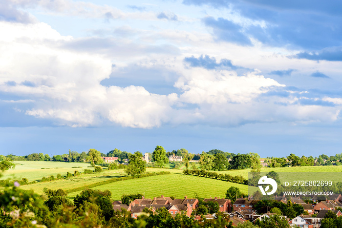 new estate village in england with cloudy sky on sunny evening