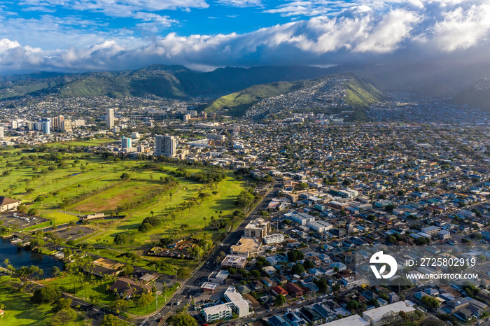 Aerial view on Honolulu suburbs located on green land and mountains, Oahu Island, Hawaii