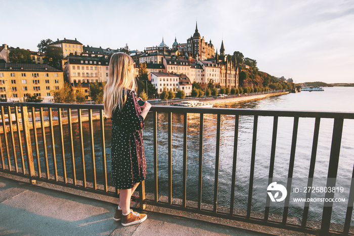 Woman traveling in Stockholm city enjoying view from bridge summer vacations in Sweden