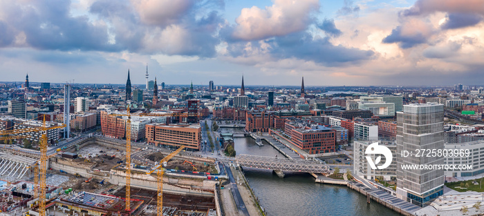 Aerial drone panoramic view of port of Hamburg from above before sunset with dramatic stormy clouds 