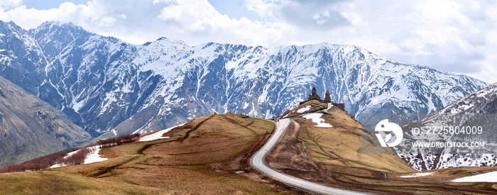 Panoramic view of Holy Trinity Church in early spring in Gergeti village, Georgia