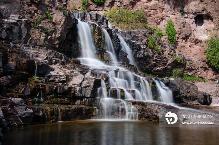 Daytime long exposure of Gooseberry Falls waterfalls at the state park in Minnesota in summer