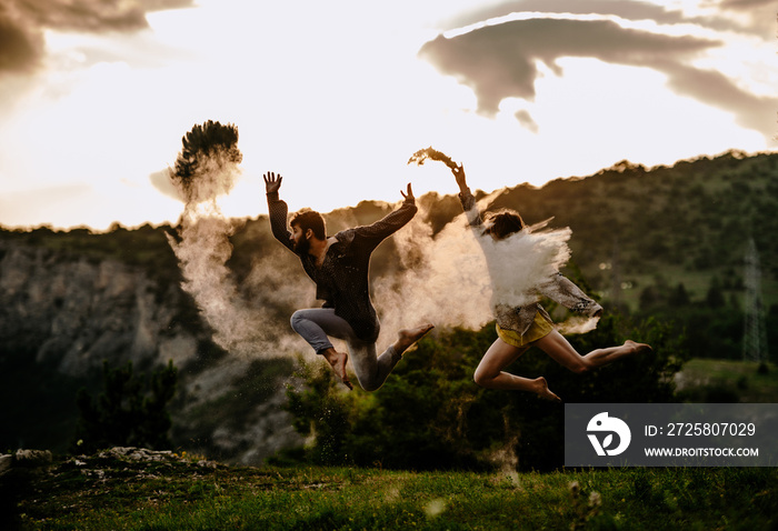 Happy romantic couple dancing open air under sunset sky