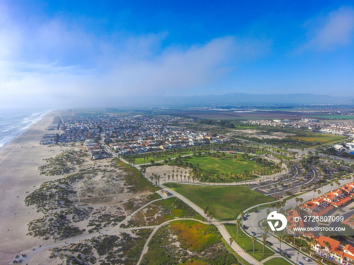 a stunning aerial shot of the beach front homes and city of Oxnard surrounding Oxnard State Beach Pa