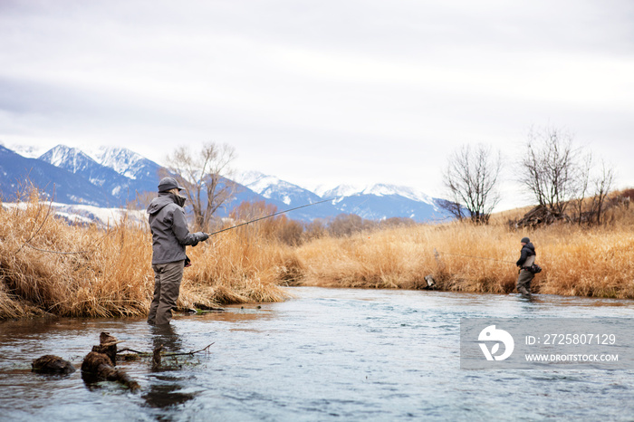 Two People Fishing In Stream