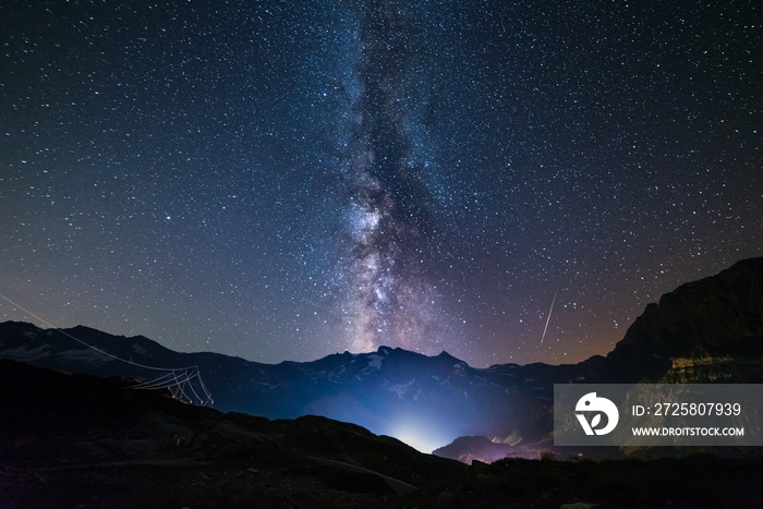 the Milky way galaxy and stars over the Italian French Alps. Night sky on majestic snowcapped mounta