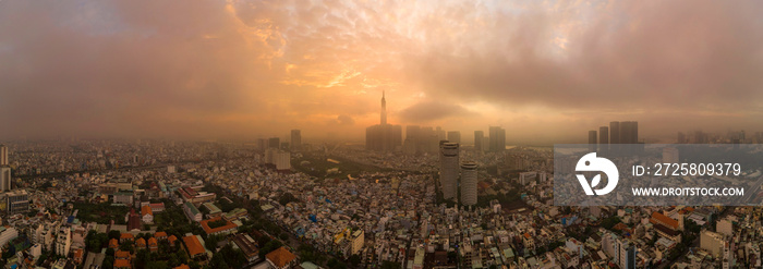 Beautiful aerial urban sunrise in Southeast Asia due to an extreme air pollution level. Ho Chi Minh 