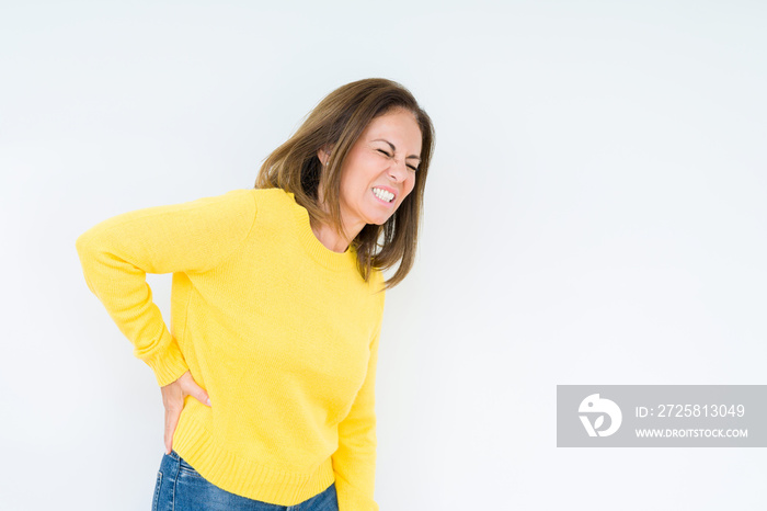 Beautiful middle age woman wearing yellow sweater over isolated background Suffering of backache, to