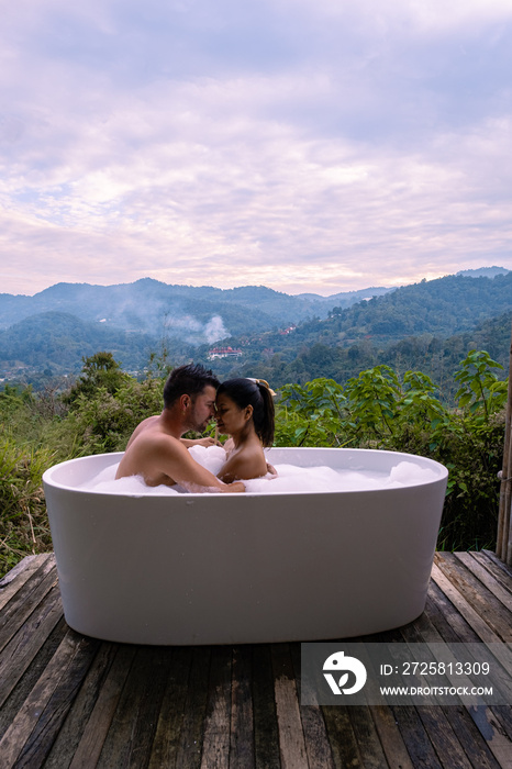 Bathtub during sunset in the mountains of Chiang Mai Thailand, relaxing in outdoor wood fire hot tub