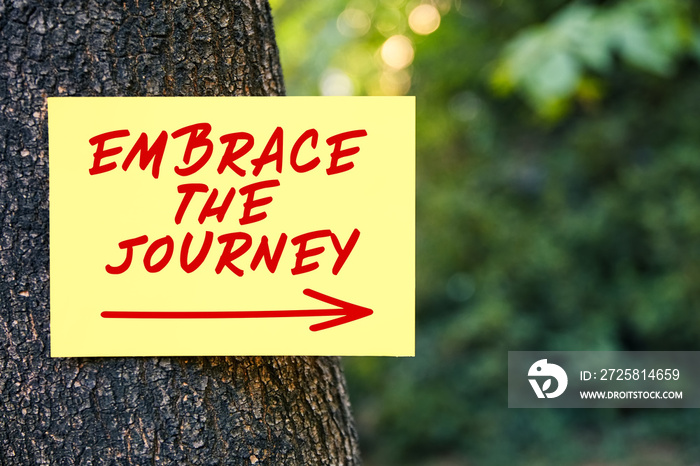 Inspirational motivational quote of embrace the journey on a tree in nature. New experience, discove