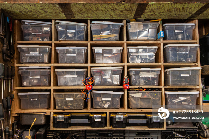 Metalwork hardware organized in tubs. A front view of metalworking hardware objects sorted into plas