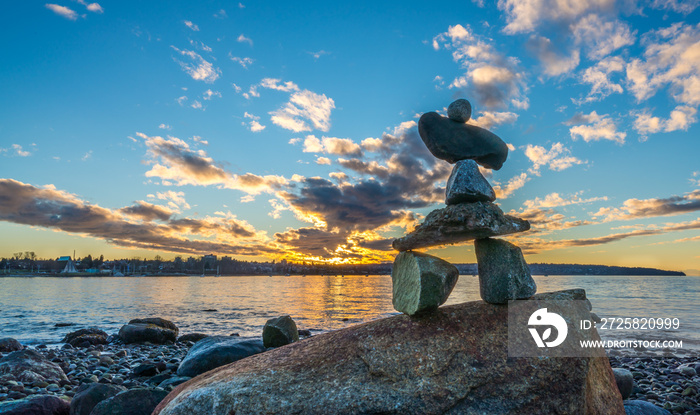 inukshuk in the sunset on the beach