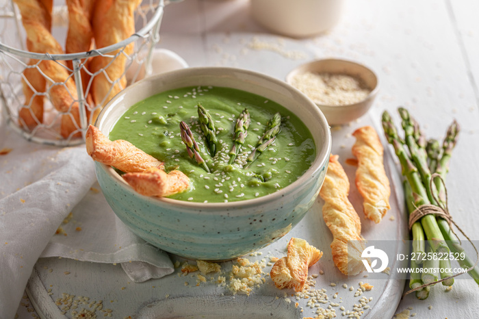 Healthy creamy asparagus soup as healthy diet for spring.