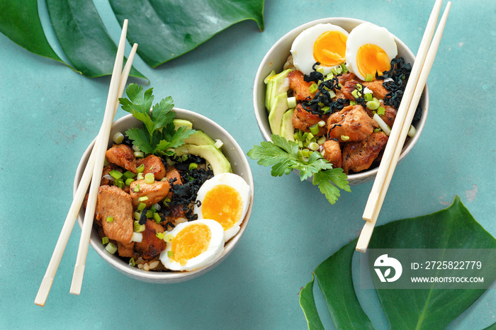 Two poke bowl fried rice chicken fillet eggs top view Asian food
