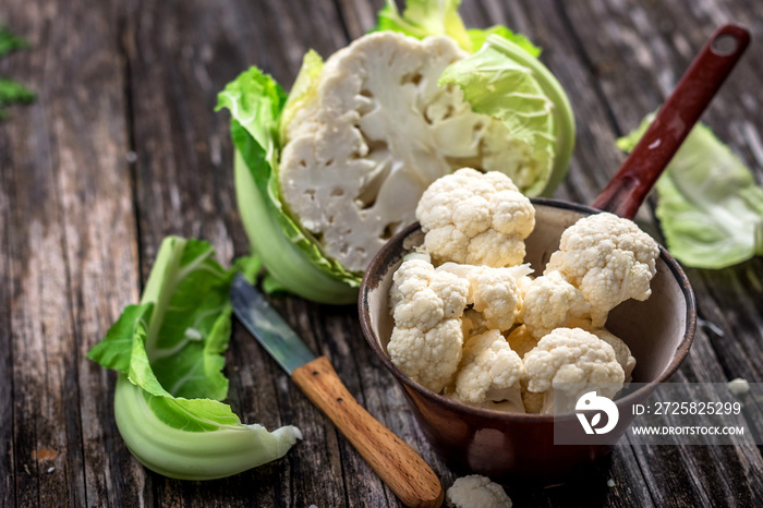 Organic cauliflower on wooden background