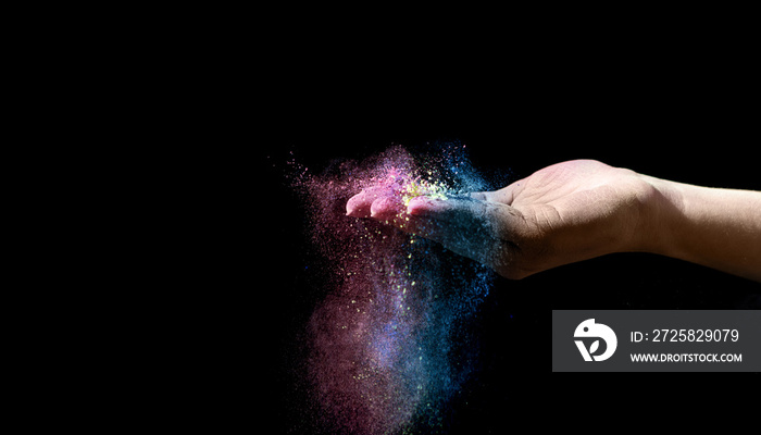 Magical colored holi powder explosion on the woman palm