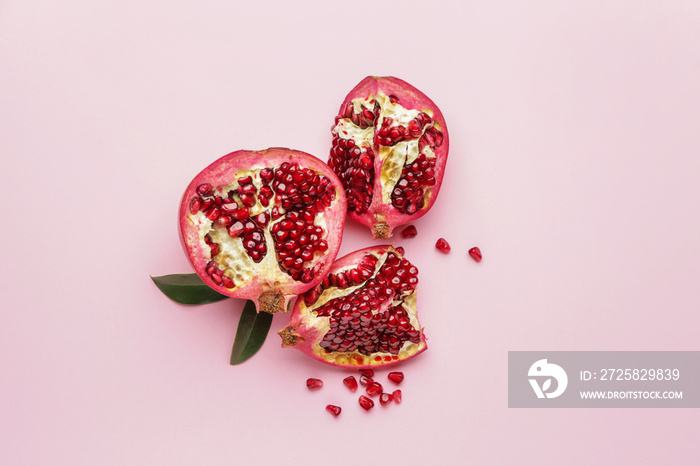 Ripe juicy pomegranates on color background