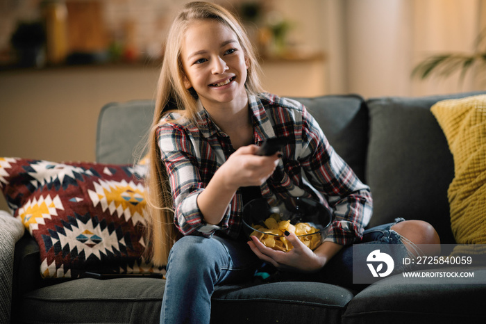 Teenage girl watching TV. Pretty girl watching movie.