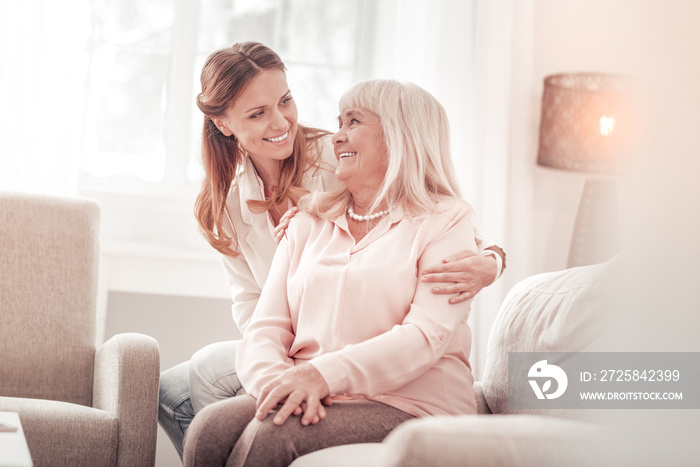 Amazing mother and daughter smiling tenderly to each other