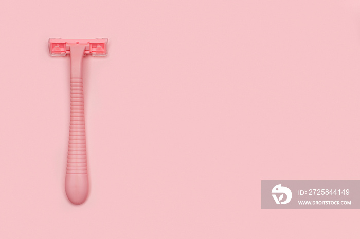 Pink woman shaver isolated on pink paper background. Copy space, place for text. Flat lay. Shaving c