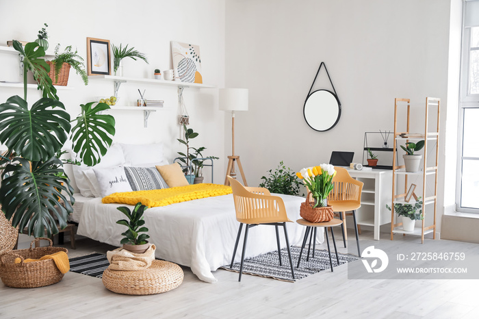 Stylish interior of modern bedroom with houseplants