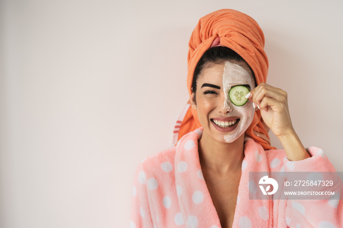 Happy smiling girl applying facial organic cream - Healthy beauty treatment and self care lifestyle 