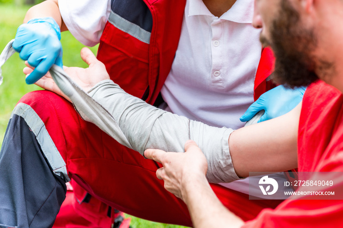 Medical worker treating burns in the field. Paramedic training, professional injury make-up