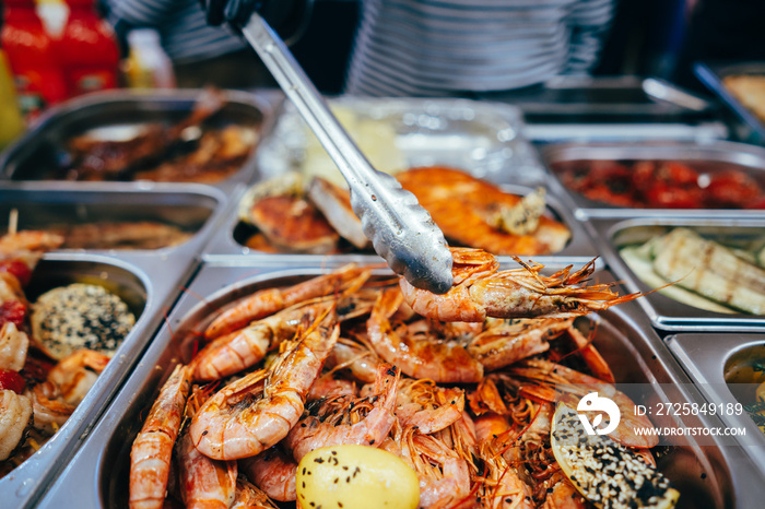 tray with many fried shrimp in the street restaurant