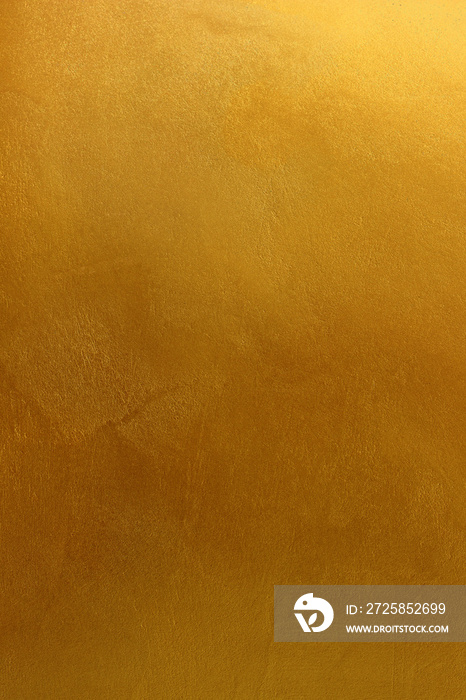 水泥墙纹理或背景上的金色或黄色油漆