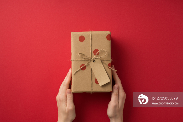 First person top view photo of valentines day decorations womans hands giving craft paper giftbox 