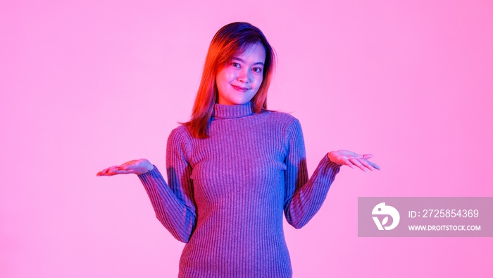 Portrait studio shot of millennial Asian young teen female model in gray turtleneck sweater standing