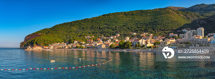 View on Petrovac and its beach in summer full of tourists