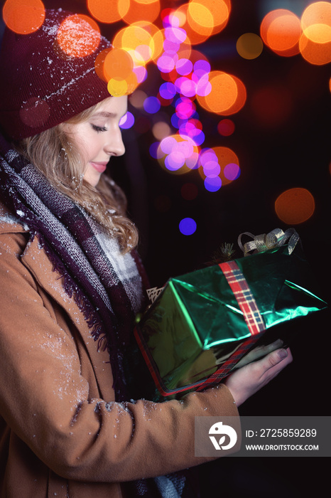 Smiling young girl with a christmas gift