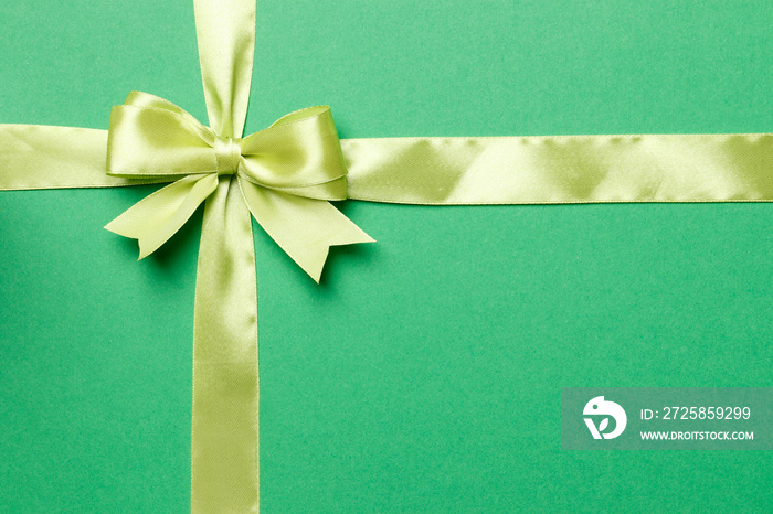 light green bow and ribbon isolated on green background