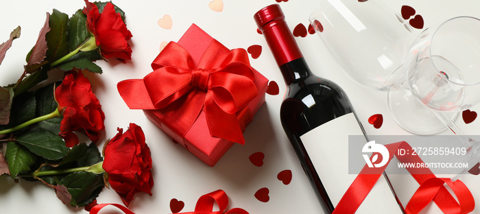 Concept of Happy Valentines day with wine, roses and gift box on white background