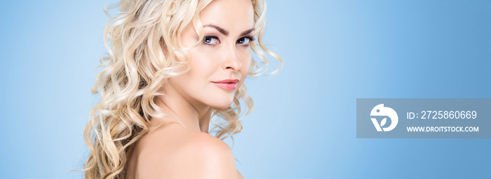 Beauty portrait of attractive blond woman with curly hair and a beautiful hairstyle. Makeup and cosm