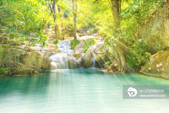 Tropical landscape with beautiful waterfall and emerald lake in green wild jungle forest. Erawan Nat