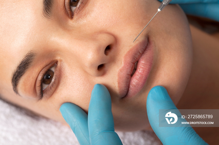 Young woman undergoing procedure of bb glow treatment in beauty salon