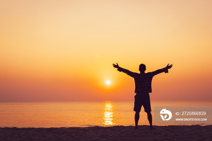 Copy space of man rise hand up on sunset sky at beach and island background.