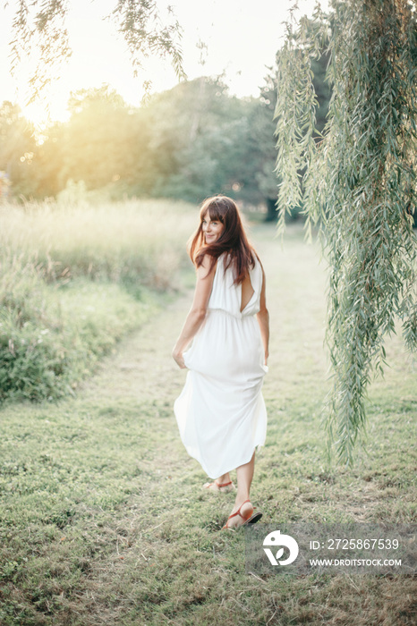 Beautiful happy smiling middle age young Caucasian woman with long dark brown red hair. Casual style