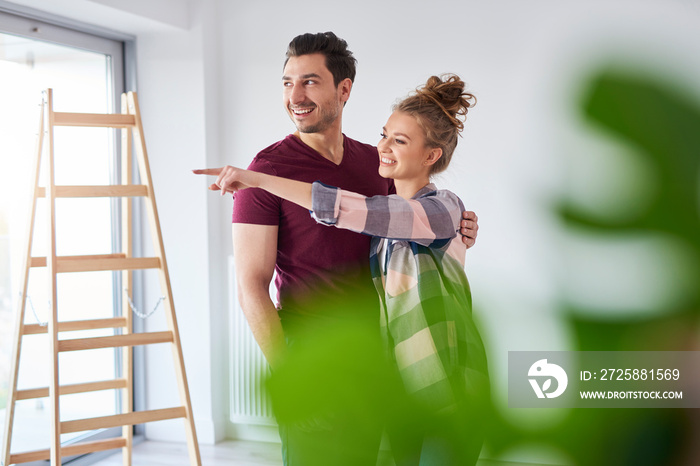 Young couple making plans for home improvement