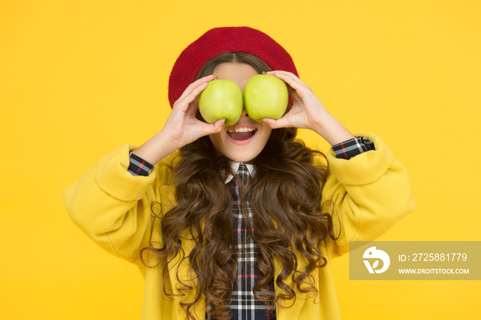 Eating apples improve learning. Small child hold apples yellow background. Little girl have fun with