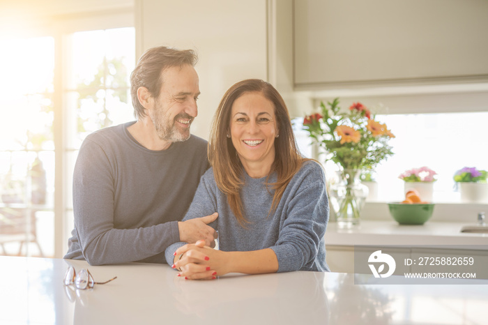 Romantic middle age couple sitting together at home