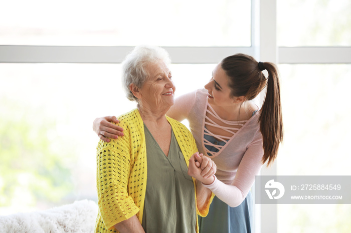 Caregiver with senior woman in nursing home