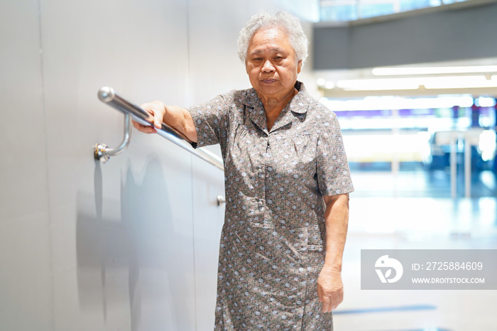 Asian senior or elderly old lady woman patient use slope walkway handle security with help support a