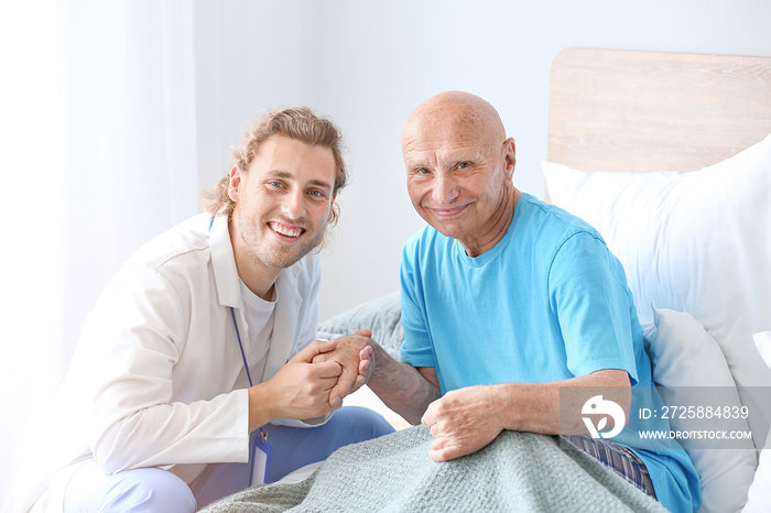 Doctor with elderly man in nursing home