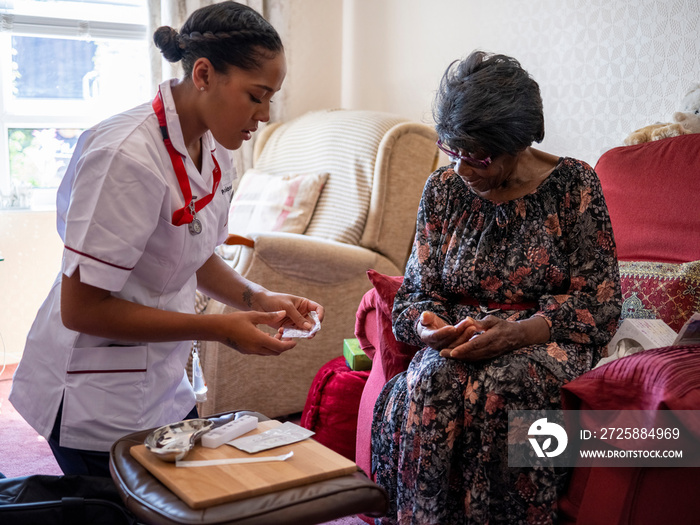 Nurse�taking care of elderly woman, administering medications