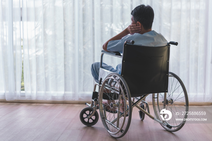 Man patients sit alone on a wheelchair.