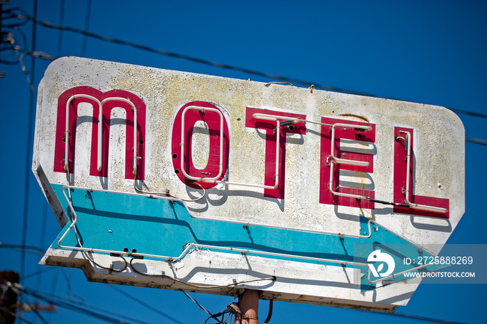 A dilapidated, vintage motel sign in the desert of Arizona