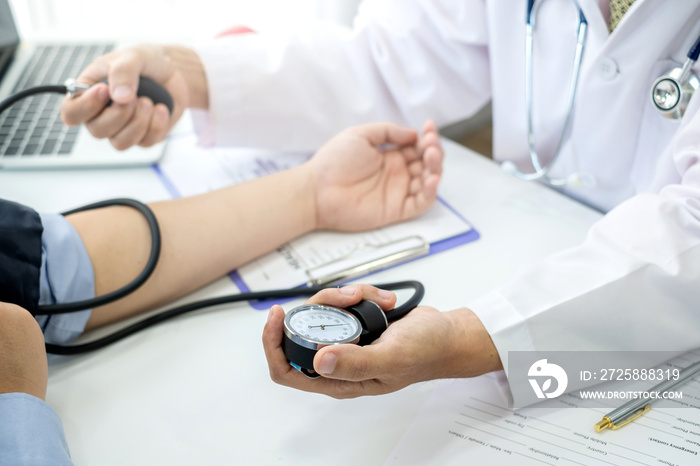 The doctor is checking the blood pressure of the patient.